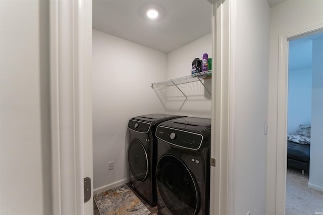 clothes washing area featuring carpet flooring and independent washer and dryer