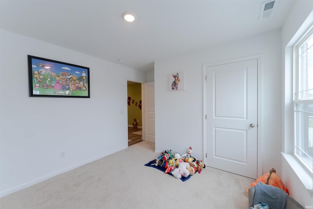 playroom featuring light colored carpet