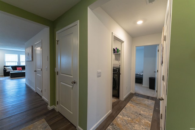 corridor featuring washer / dryer and dark wood-type flooring