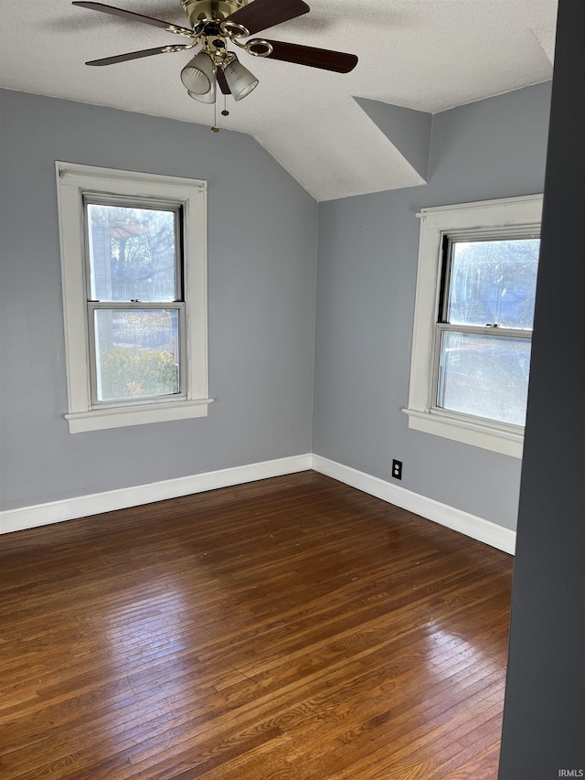 bonus room with lofted ceiling, dark hardwood / wood-style floors, a textured ceiling, and a wealth of natural light