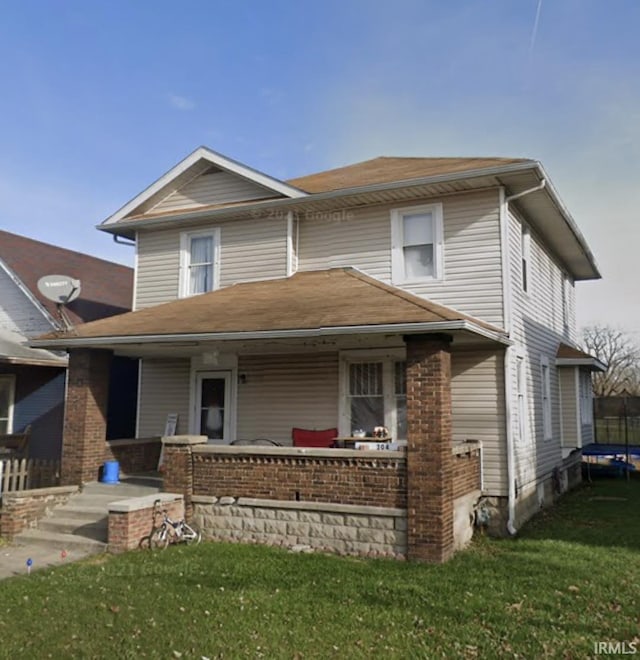 view of front of home featuring a trampoline and a front lawn