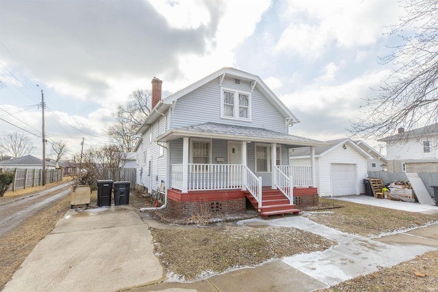 bungalow-style home featuring a garage, an outdoor structure, and covered porch