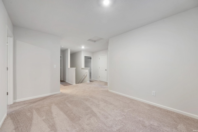 unfurnished room with light colored carpet