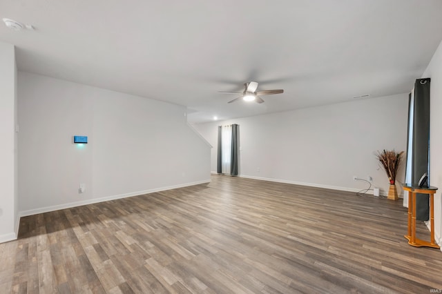 unfurnished living room with wood-type flooring and ceiling fan