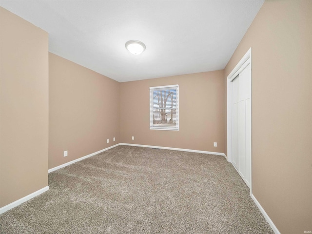 unfurnished room featuring carpet flooring