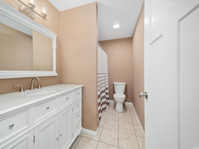 bathroom featuring vanity, tile patterned floors, and toilet