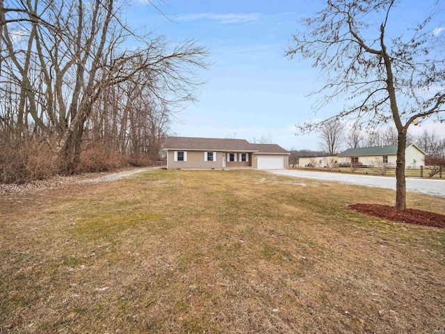 ranch-style house featuring a garage and a front lawn