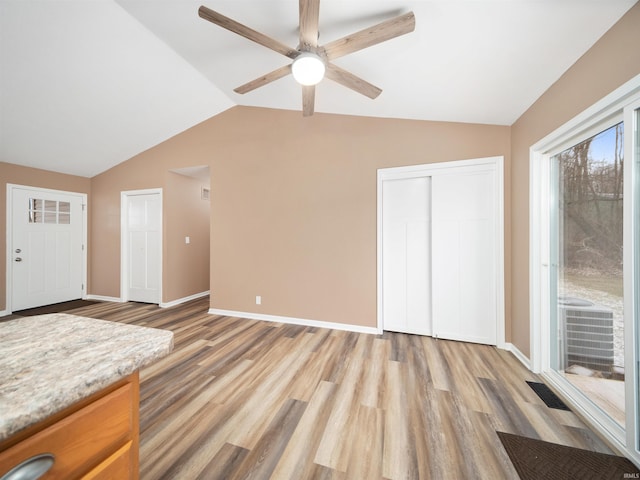 interior space featuring ceiling fan, light hardwood / wood-style floors, and vaulted ceiling