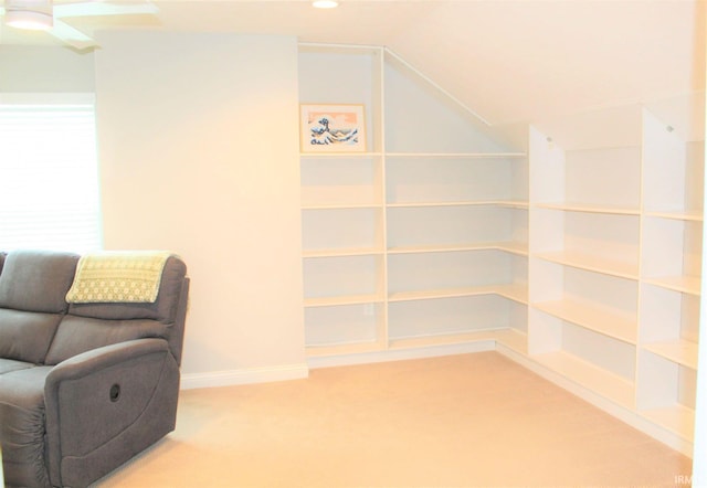 living area with vaulted ceiling and carpet floors