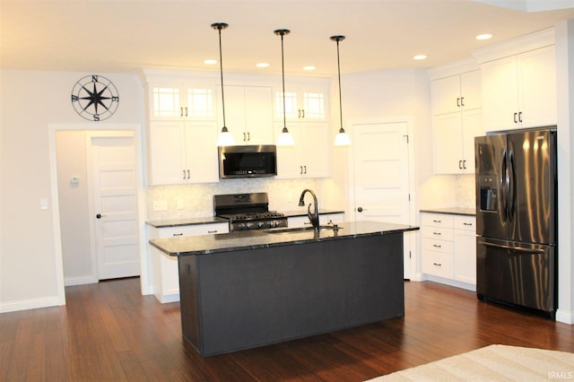 kitchen featuring pendant lighting, white cabinets, dark hardwood / wood-style flooring, a kitchen island with sink, and stainless steel appliances