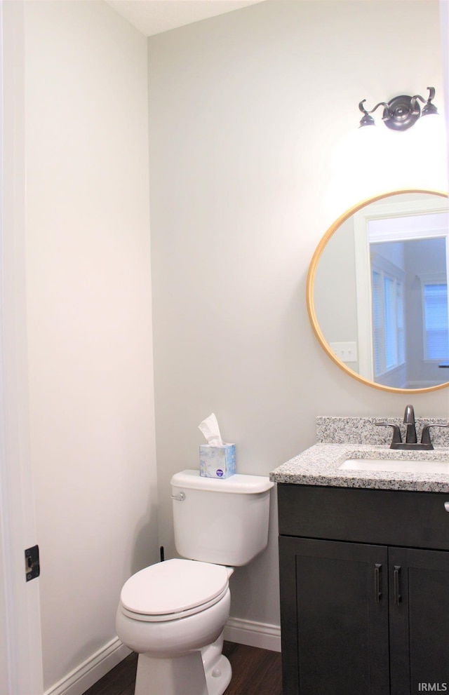 bathroom featuring vanity, hardwood / wood-style flooring, and toilet