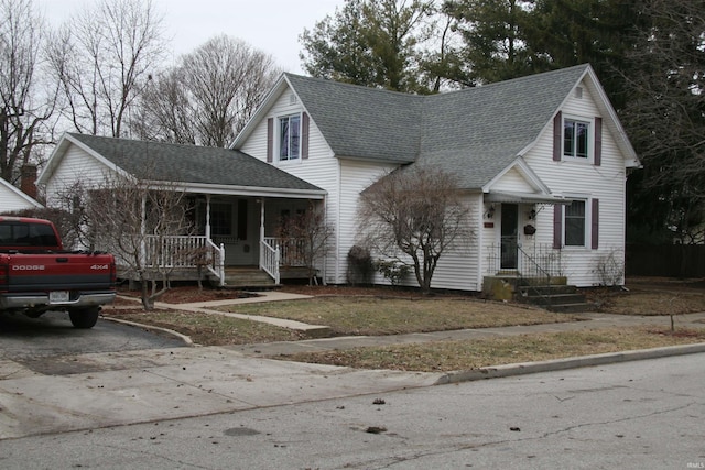 view of front of property featuring a porch and roof with shingles