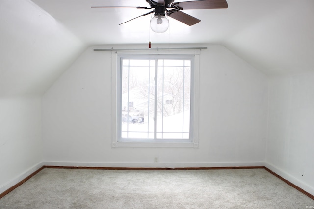 bonus room featuring baseboards, vaulted ceiling, and light colored carpet