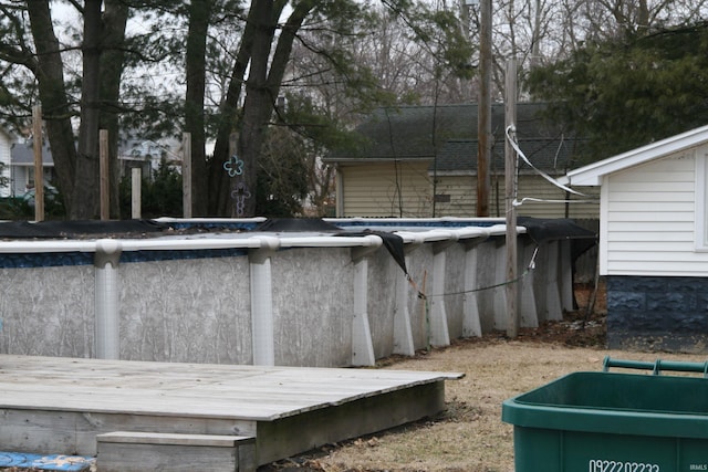 outdoor pool with a wooden deck