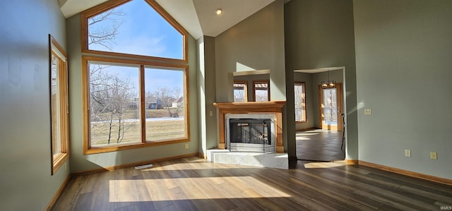 unfurnished living room with hardwood / wood-style flooring, plenty of natural light, and a fireplace