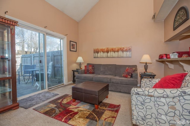 carpeted living room featuring high vaulted ceiling