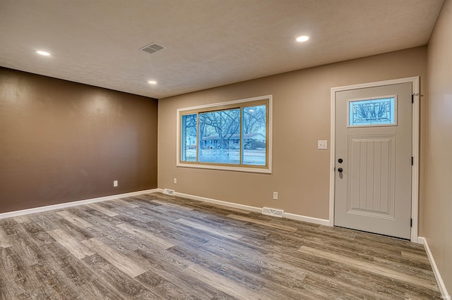 entryway featuring wood finished floors, visible vents, and baseboards