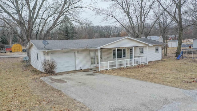 single story home with a garage, covered porch, and a front lawn