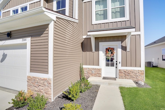 doorway to property featuring a garage and central AC unit