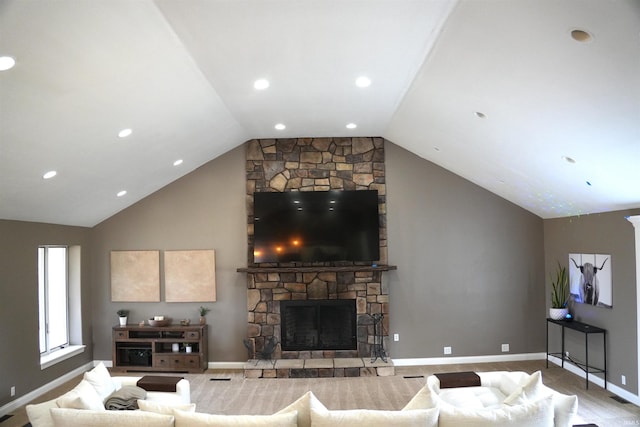 living room featuring a stone fireplace and vaulted ceiling