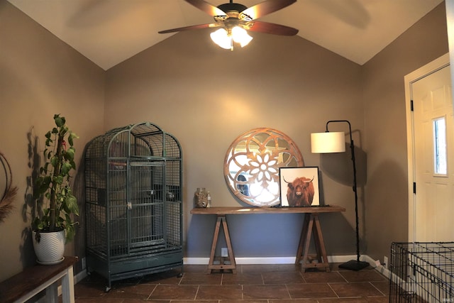 foyer featuring lofted ceiling, dark tile patterned flooring, and ceiling fan