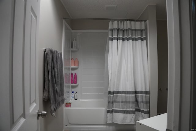 bathroom featuring a textured ceiling and shower / bath combo