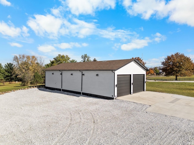 garage featuring a lawn