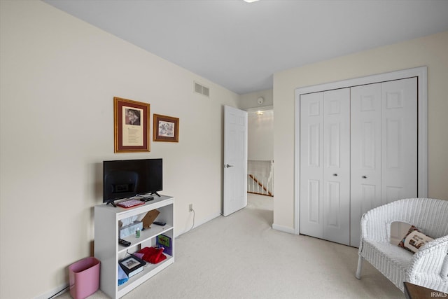 living area featuring light carpet