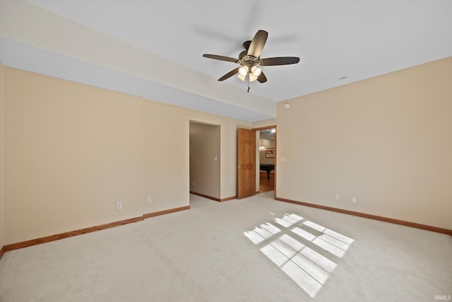 carpeted spare room featuring ceiling fan