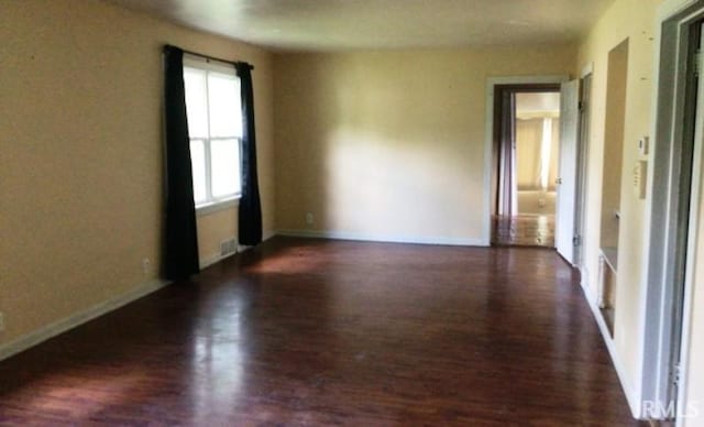 empty room featuring dark hardwood / wood-style flooring