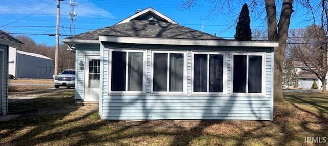 view of side of property with a yard