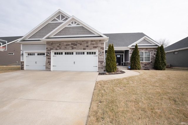 craftsman-style house featuring a garage and a front lawn