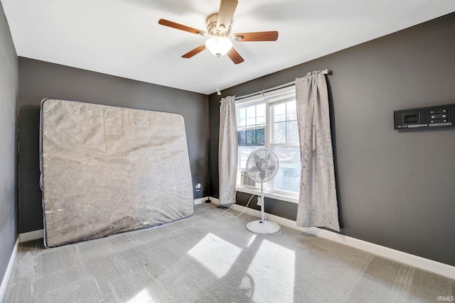 spare room featuring light colored carpet and ceiling fan