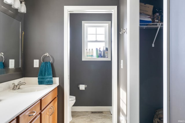 bathroom featuring vanity and toilet