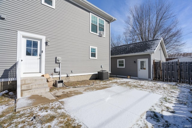 snow covered property featuring central air condition unit