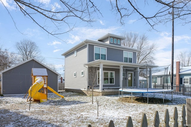 view of front of home with a trampoline and a playground