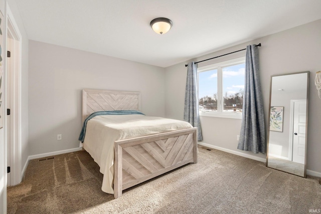 carpeted bedroom featuring visible vents and baseboards