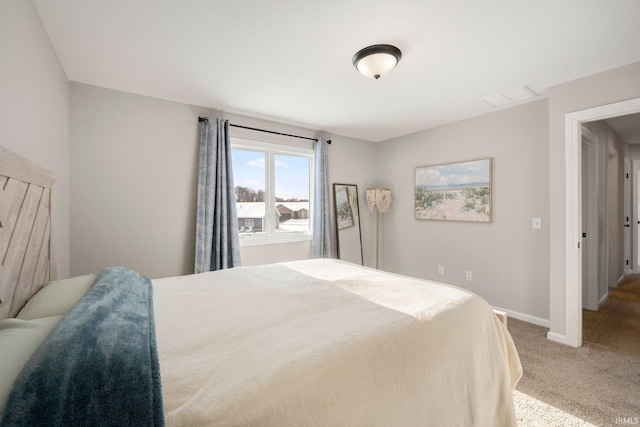 carpeted bedroom with baseboards and visible vents