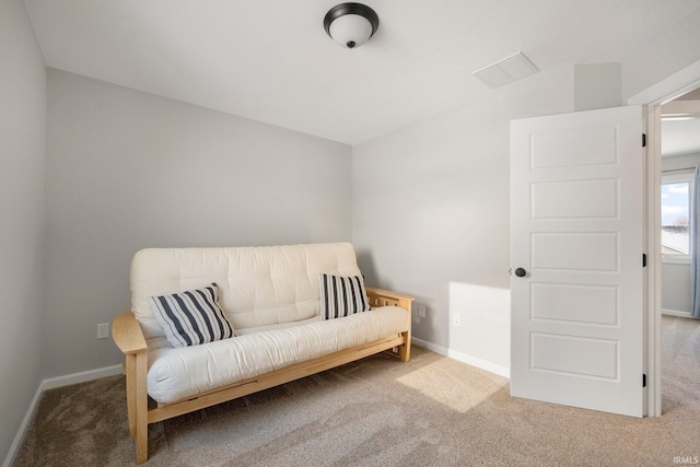 living area featuring carpet and baseboards