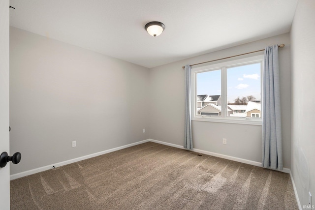 spare room with carpet floors and baseboards