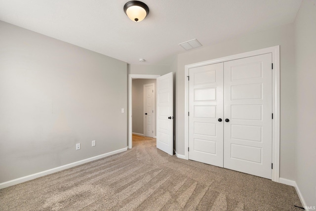 unfurnished bedroom featuring a closet, carpet, and baseboards