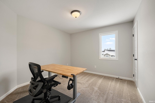 carpeted home office with baseboards