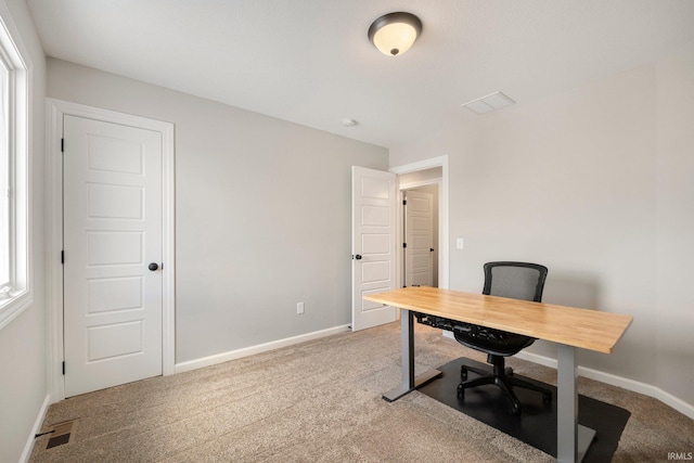 carpeted office featuring baseboards and visible vents