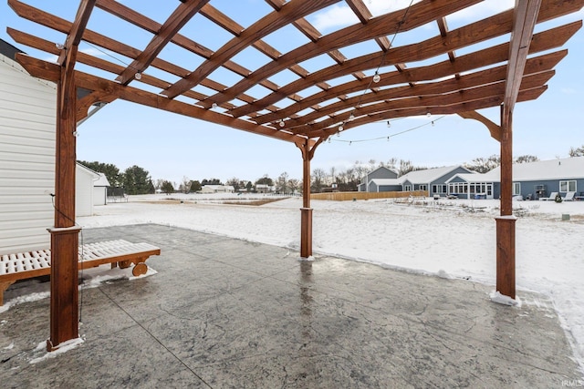 snow covered patio featuring a pergola