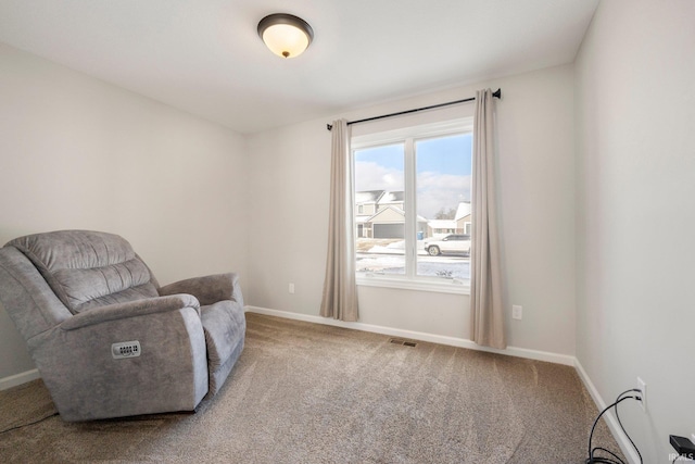 sitting room with carpet and baseboards
