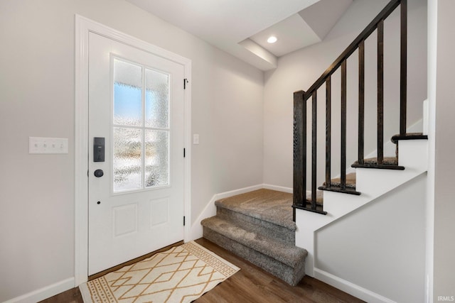 foyer entrance featuring stairway, recessed lighting, wood finished floors, and baseboards