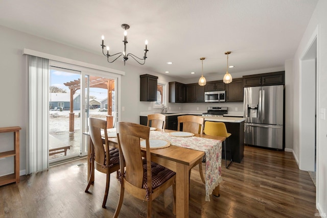 dining area featuring a notable chandelier, baseboards, dark wood-style flooring, and recessed lighting