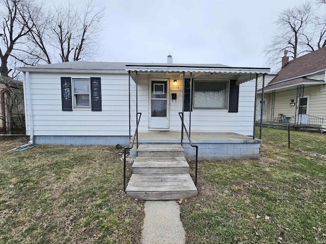 bungalow with a front yard and a porch