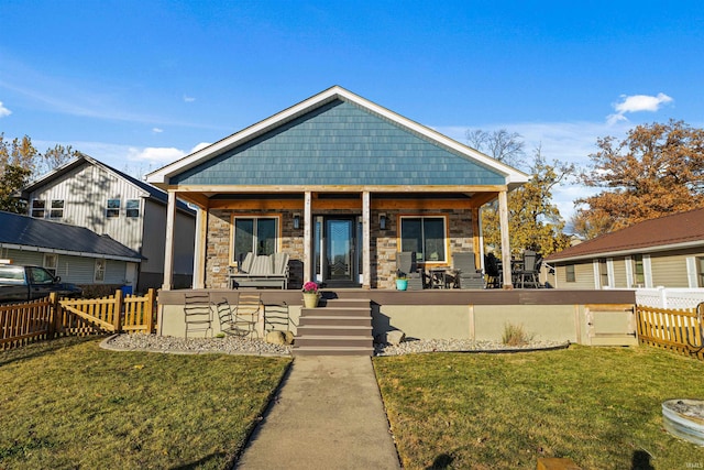 view of front of property with a porch and a front lawn