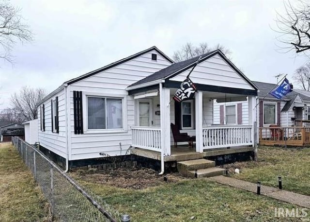 bungalow-style house with a porch and a front yard